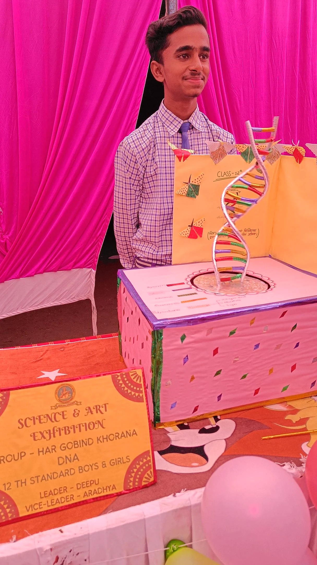 A student presenting a science and art exhibition model