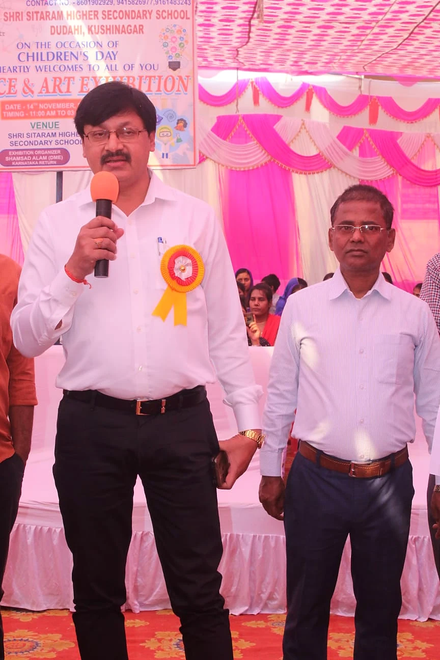 An educator addressing students during an exhibition