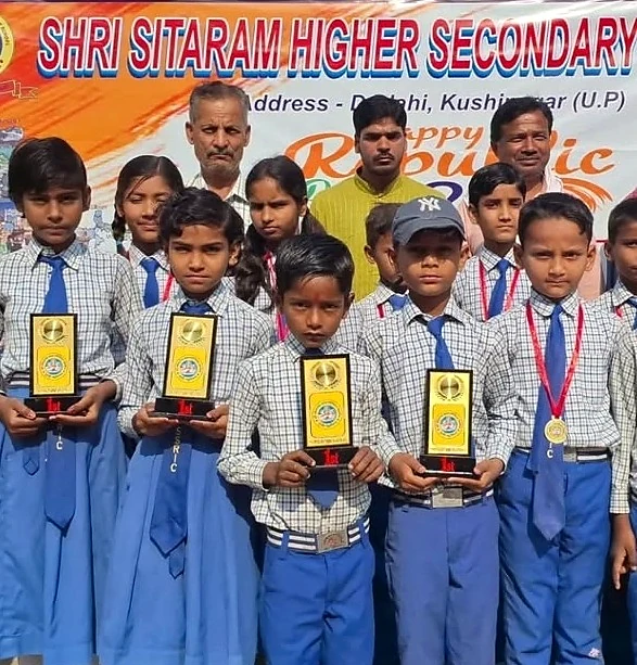 Students displaying awards with school educators